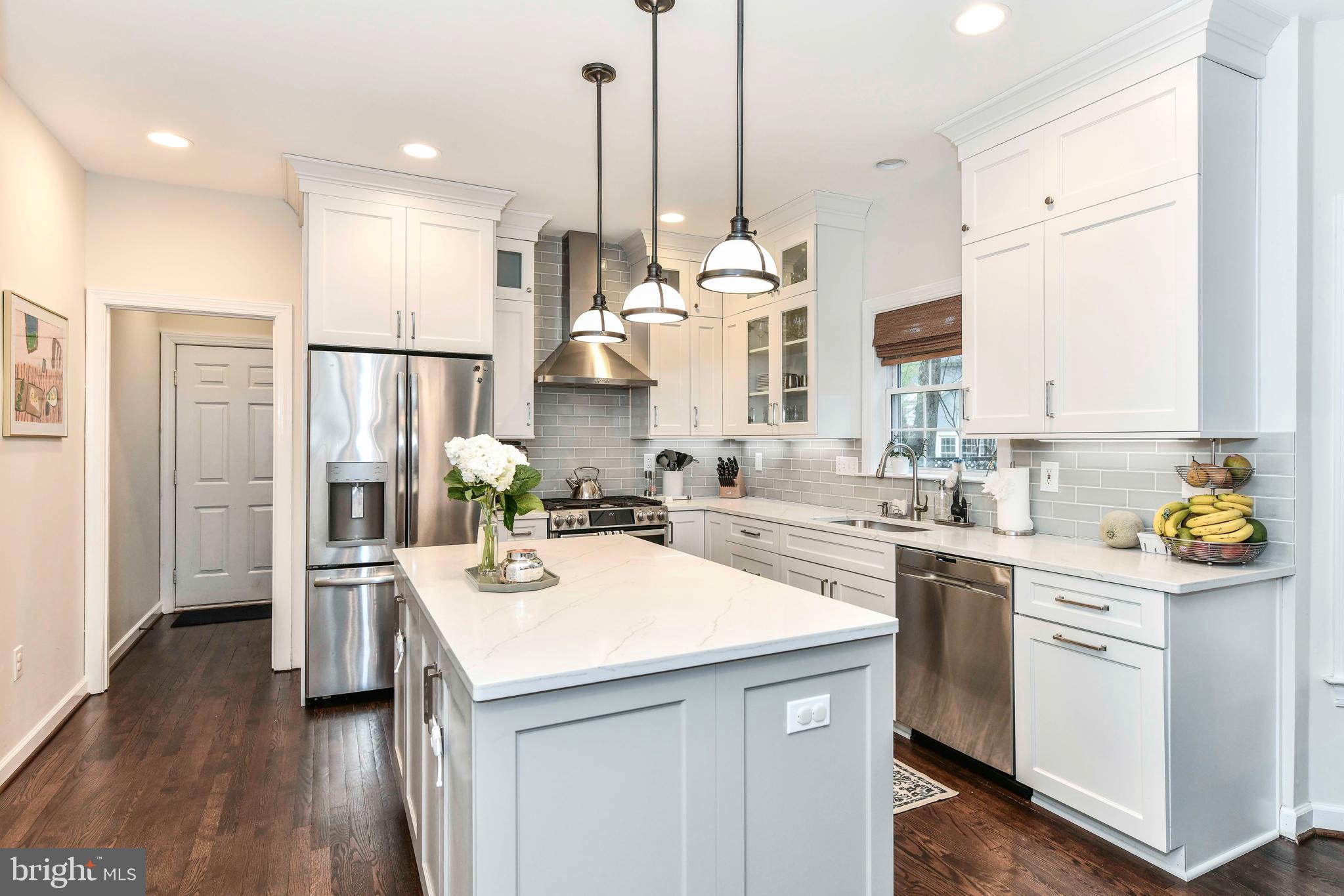 6866 Melrose Drive McLean, VA 22101 - Photo 15 of 42 a kitchen with stainless steel appliances kitchen island granite countertop a sink a counter space and cabinets