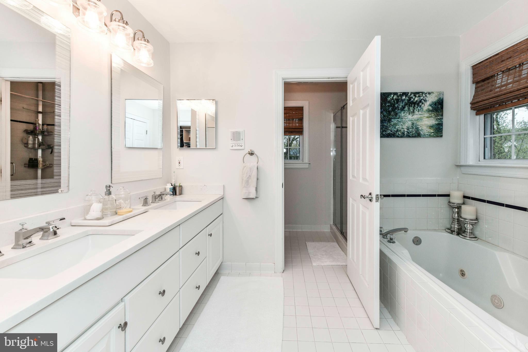6866 Melrose Drive McLean, VA 22101 - Photo 20 of 42 a bathroom with a tub double vanity sink and mirror