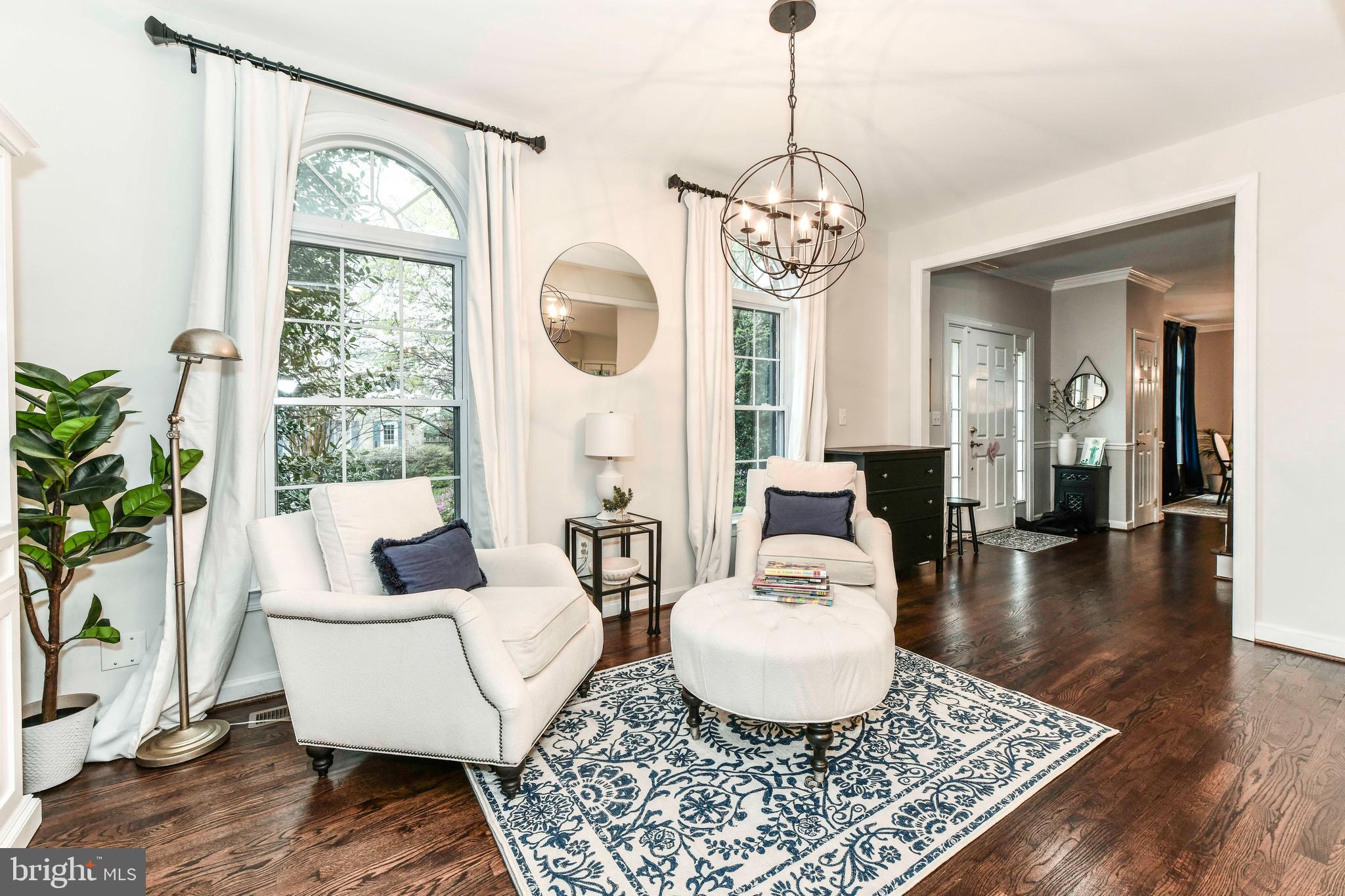 6866 Melrose Drive McLean, VA 22101 - Photo 2 of 42 a living room with couch a dining table a table and a large mirror