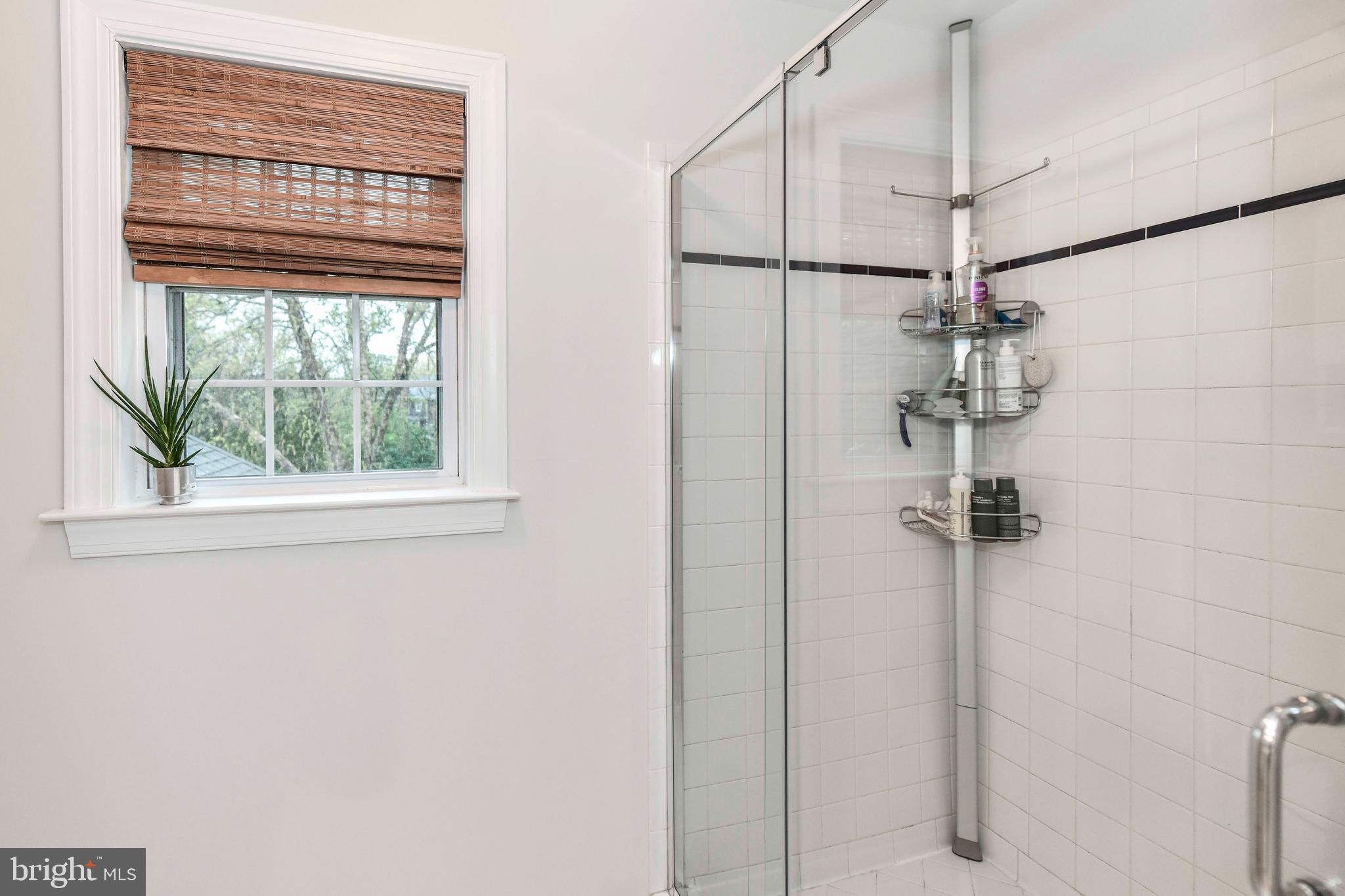 6866 Melrose Drive McLean, VA 22101 - Photo 22 of 42 a bathroom with a window and a shower