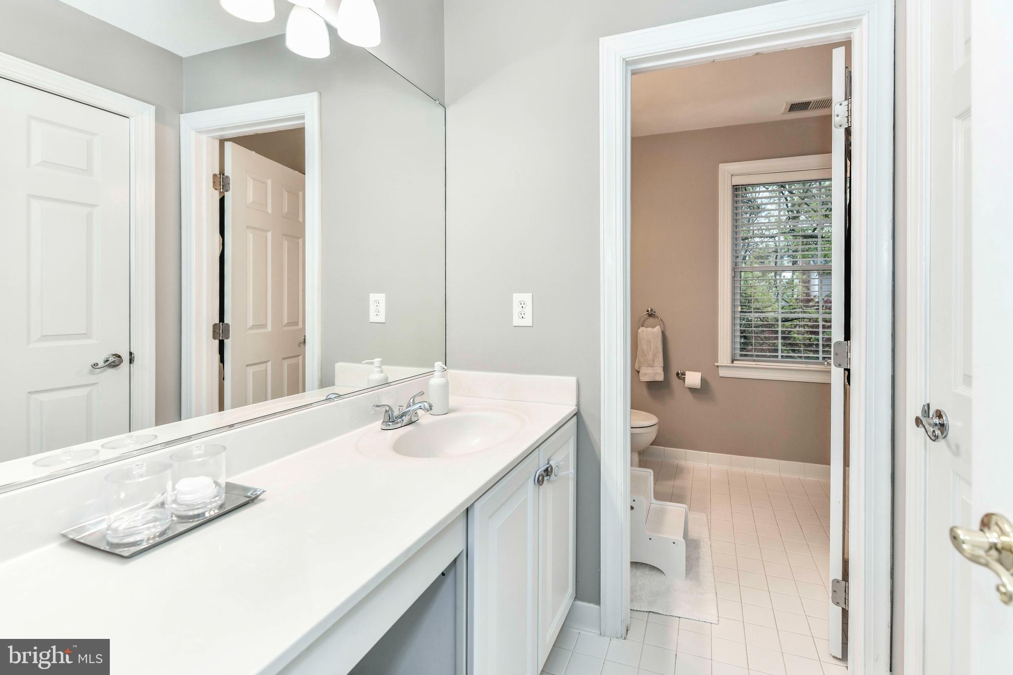 6866 Melrose Drive McLean, VA 22101 - Photo 23 of 42 a en suite bathroom with a sink and a mirror