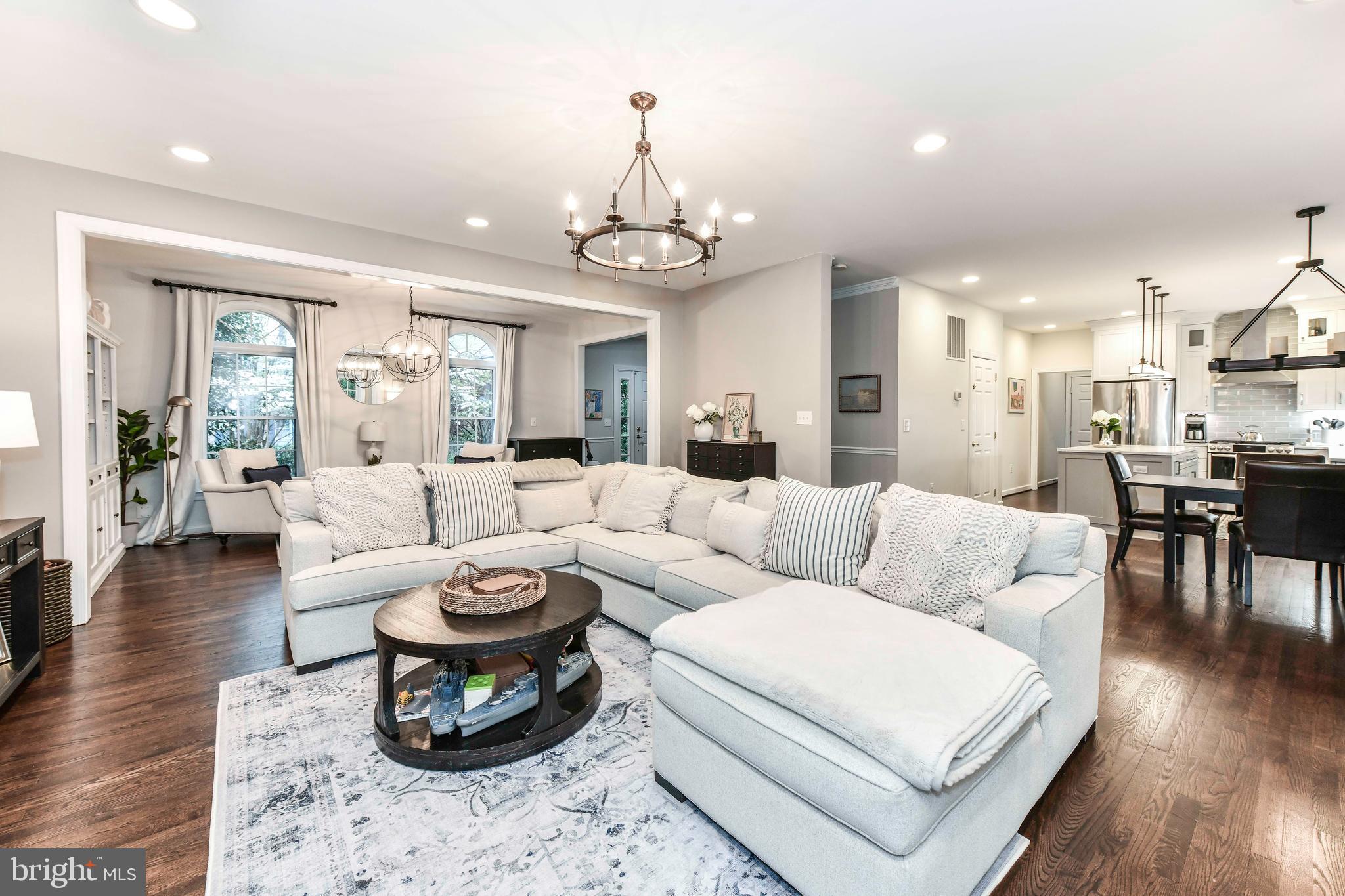 6866 Melrose Drive McLean, VA 22101 - Photo 3 of 42 a living room with furniture a wooden floor and a chandelier