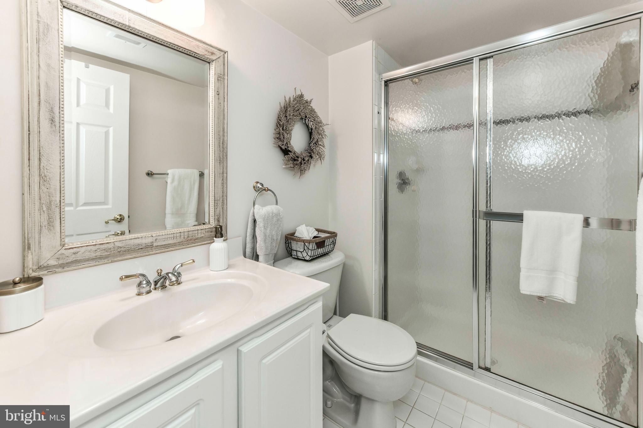 6866 Melrose Drive McLean, VA 22101 - Photo 34 of 42 a bathroom with a sink toilet and shower