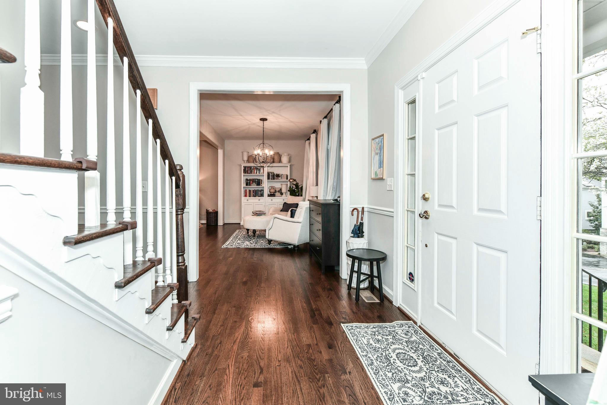 6866 Melrose Drive McLean, VA 22101 - Photo 7 of 42 a view of a hallway with wooden floor and staircase