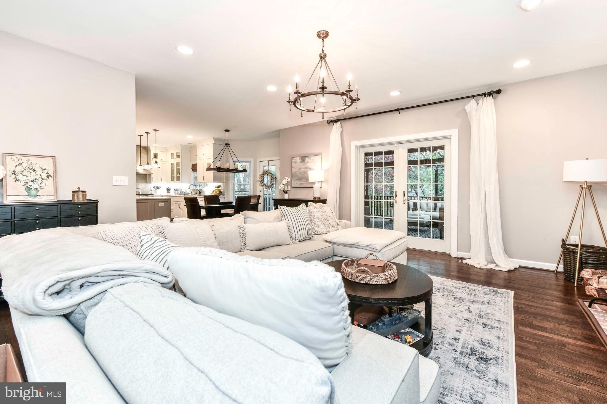 6866 Melrose Drive McLean, VA 22101 - Photo 10 of 42 a living room with furniture chandelier and a table