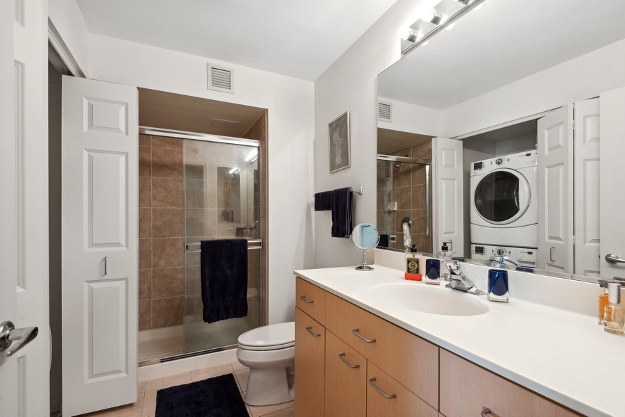 1640 Maple Avenue, Unit 1107 Evanston, IL 60201 - Photo 12 of 28 a bathroom with a double vanity sink toilet and shower