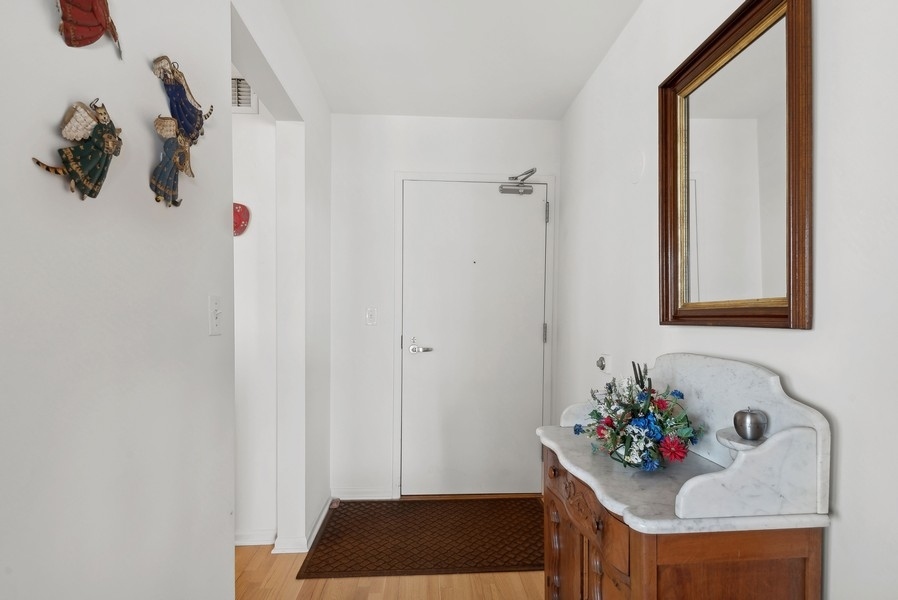 1640 Maple Avenue, Unit 1107 Evanston, IL 60201 - Photo 2 of 28 a bedroom with a bed and a chandelier