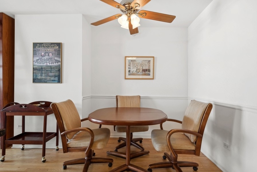 1640 Maple Avenue, Unit 1107 Evanston, IL 60201 - Photo 7 of 28 a view of a dining room with furniture and a chandelier fan