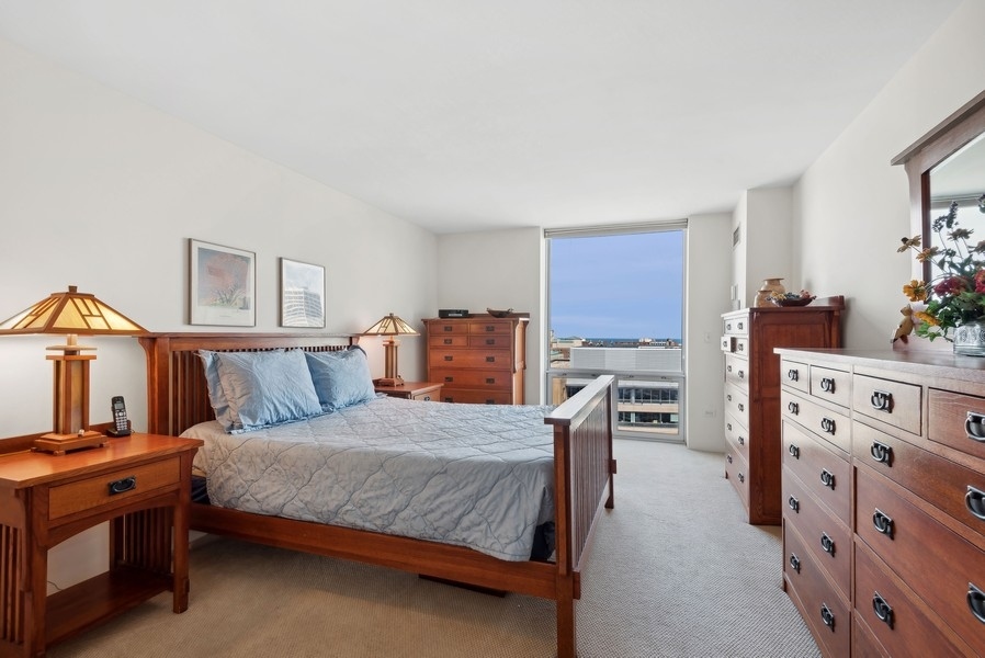 1640 Maple Avenue, Unit 1107 Evanston, IL 60201 - Photo 8 of 28 a bedroom with furniture and a dresser