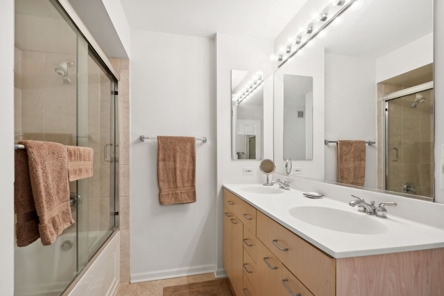 1640 Maple Avenue, Unit 1107 Evanston, IL 60201 - Photo 9 of 28 a bathroom with a double vanity sink mirror and shower