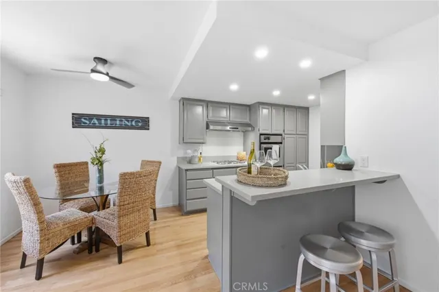a kitchen with a dining table chairs and white cabinets