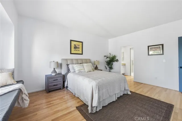 a bedroom with a bed lamp and a couch