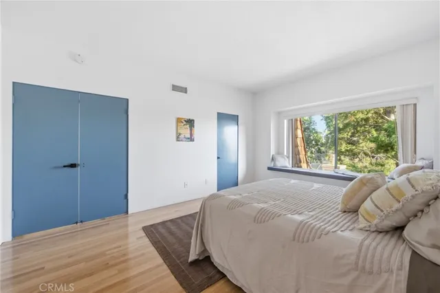 a bed sitting in a bedroom next to a window