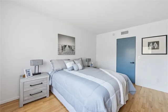 a bedroom with a bed and a night stand