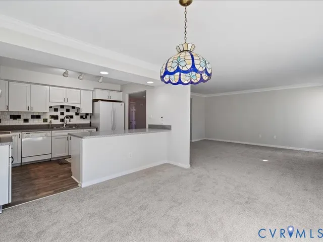 a view of a kitchen with a refrigerator stove and kitchen island