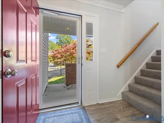 hallway with wooden floor and stairs