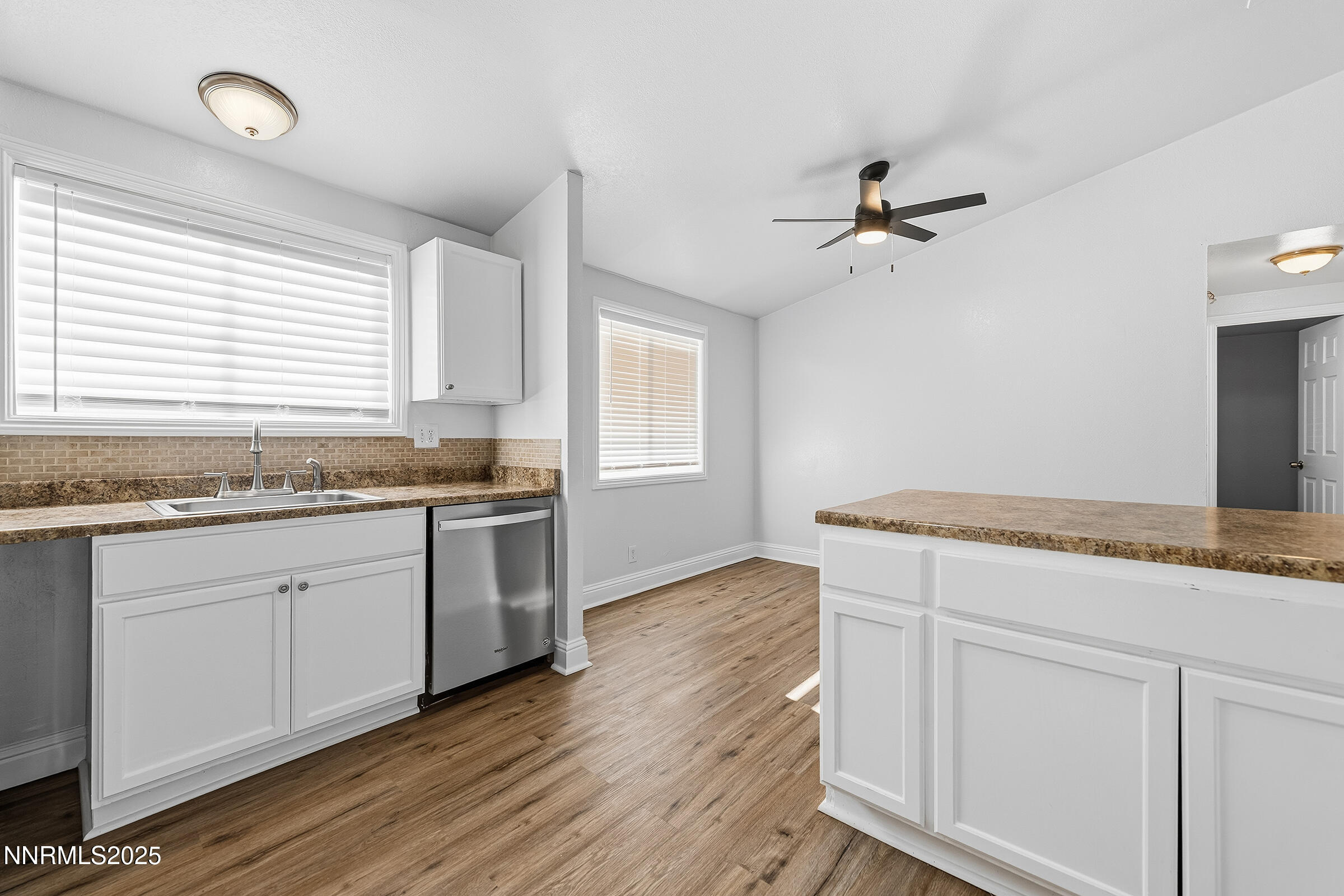 2650 Daffodil Way Reno, NV 89512 - Photo 13 of 22 a kitchen with granite countertop white cabinets and white appliances