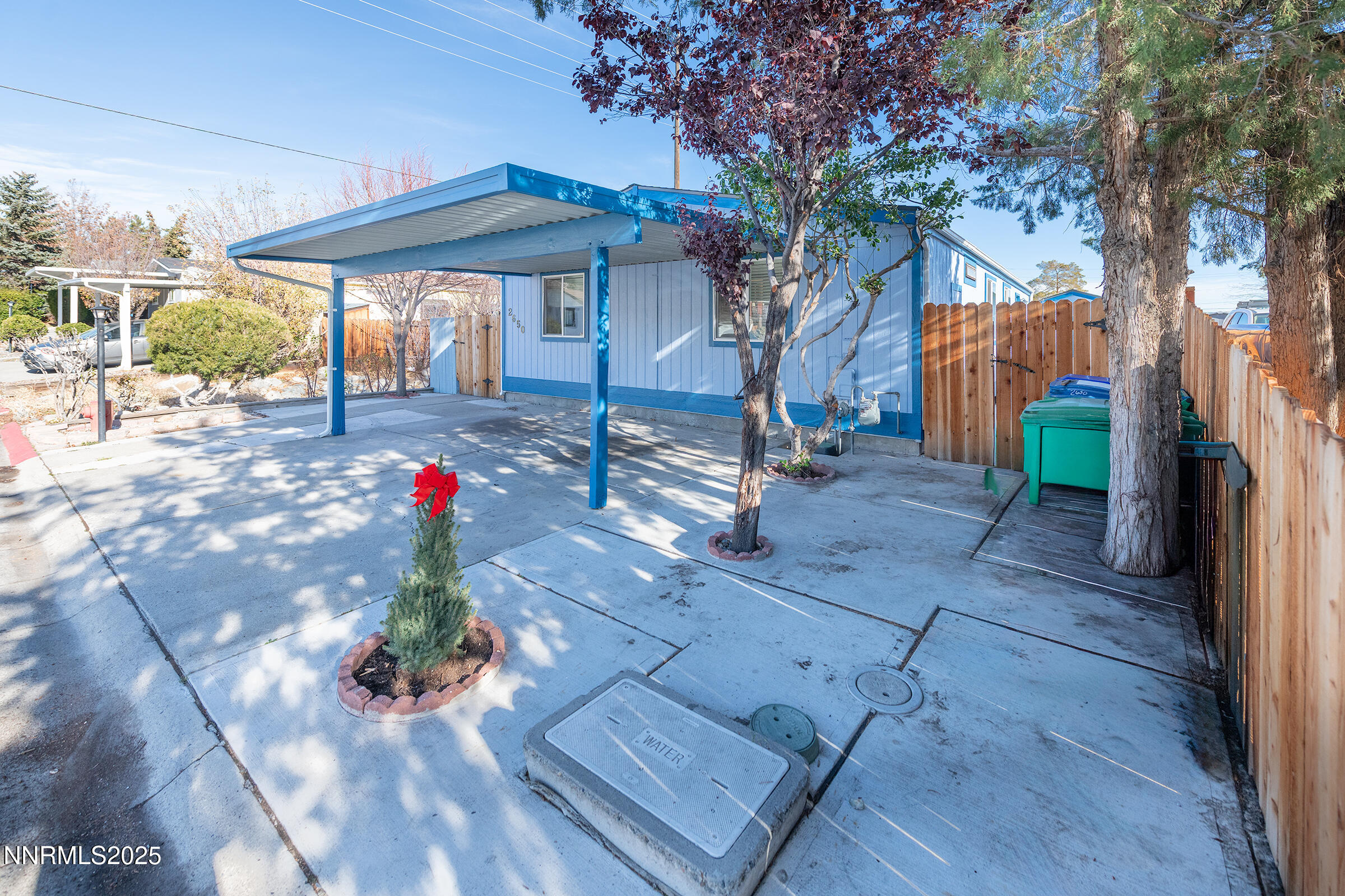 2650 Daffodil Way Reno, NV 89512 - Photo 20 of 22 a view of a patio with table and chairs under an umbrella with wooden fence