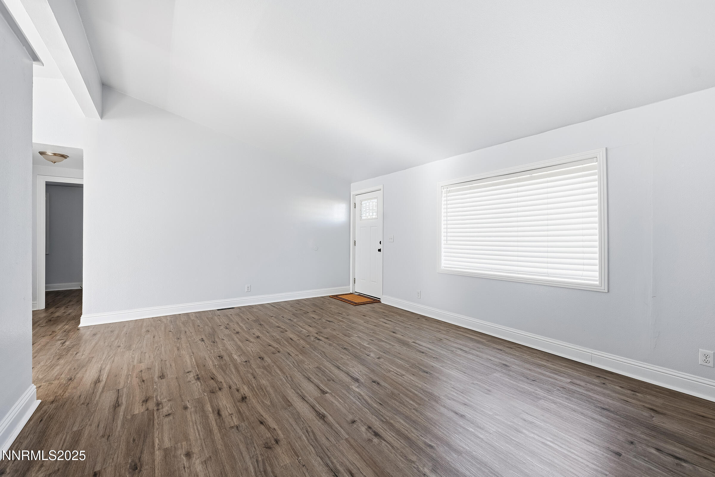 2650 Daffodil Way Reno, NV 89512 - Photo 3 of 22 an empty room with wooden floor and windows