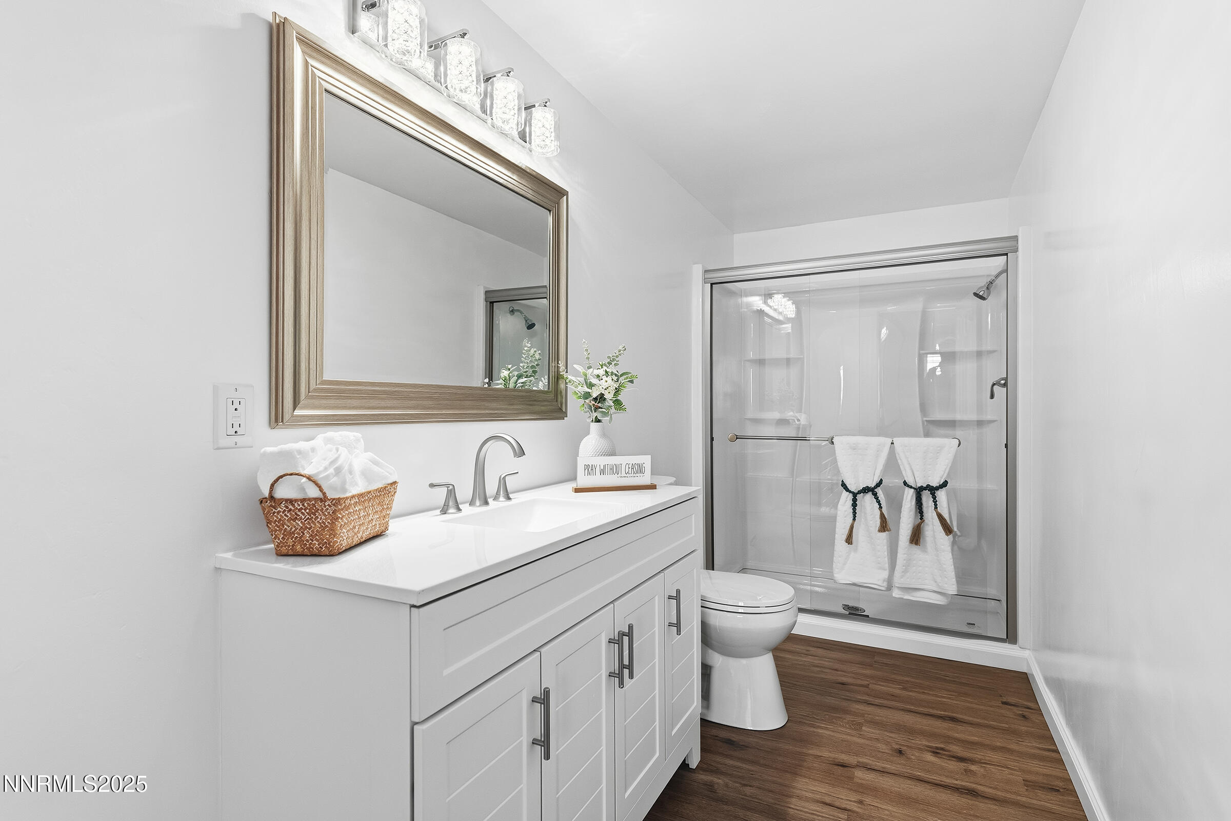 2650 Daffodil Way Reno, NV 89512 - Photo 6 of 22 a bathroom with a toilet a sink a vanity and mirror
