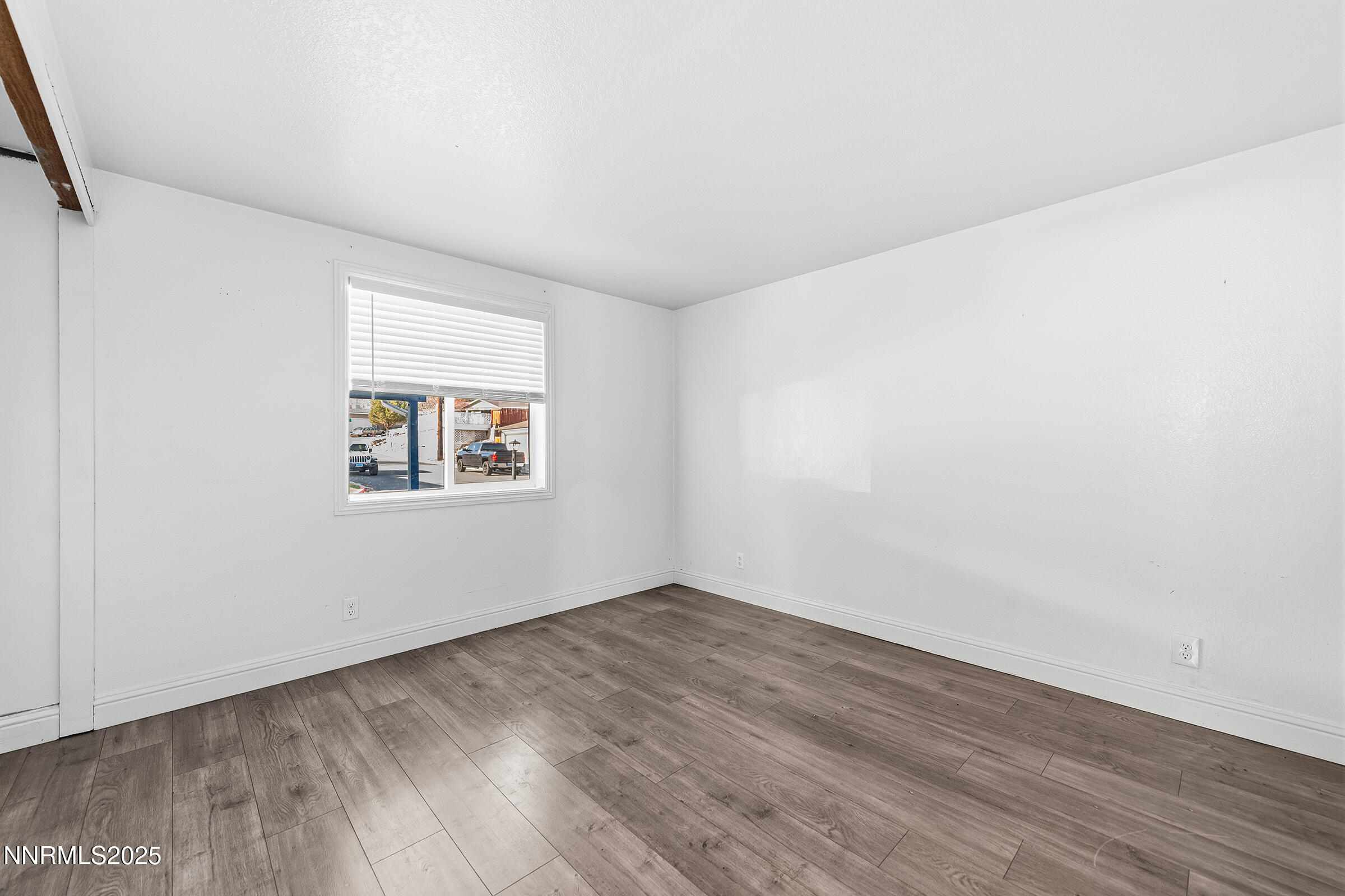2650 Daffodil Way Reno, NV 89512 - Photo 8 of 22 an empty room with wooden floor and windows