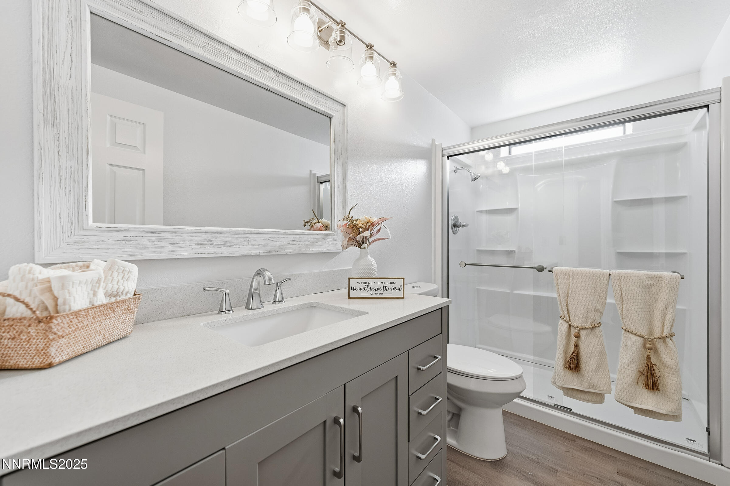 2650 Daffodil Way Reno, NV 89512 - Photo 10 of 22 a bathroom with a sink a toilet and a large mirror
