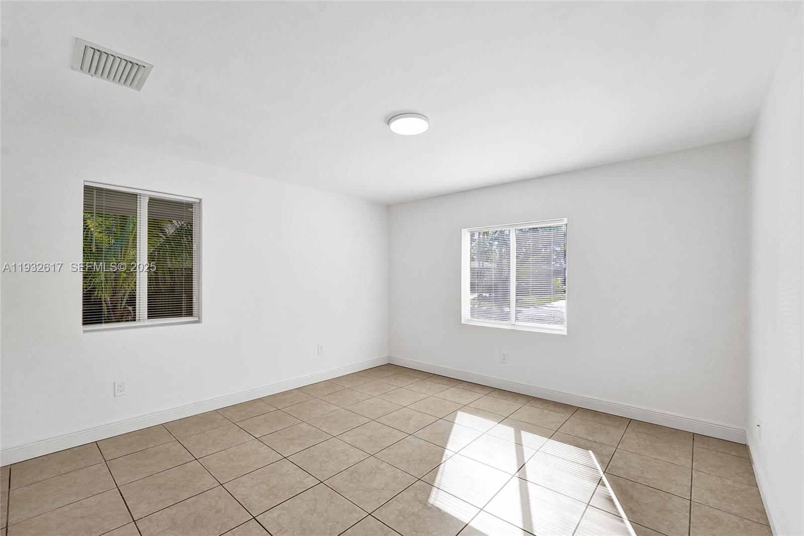 30 Southwest 8th Street, Unit 1 Hallandale Beach, FL 33009 - Photo 19 of 75 an empty room with windows