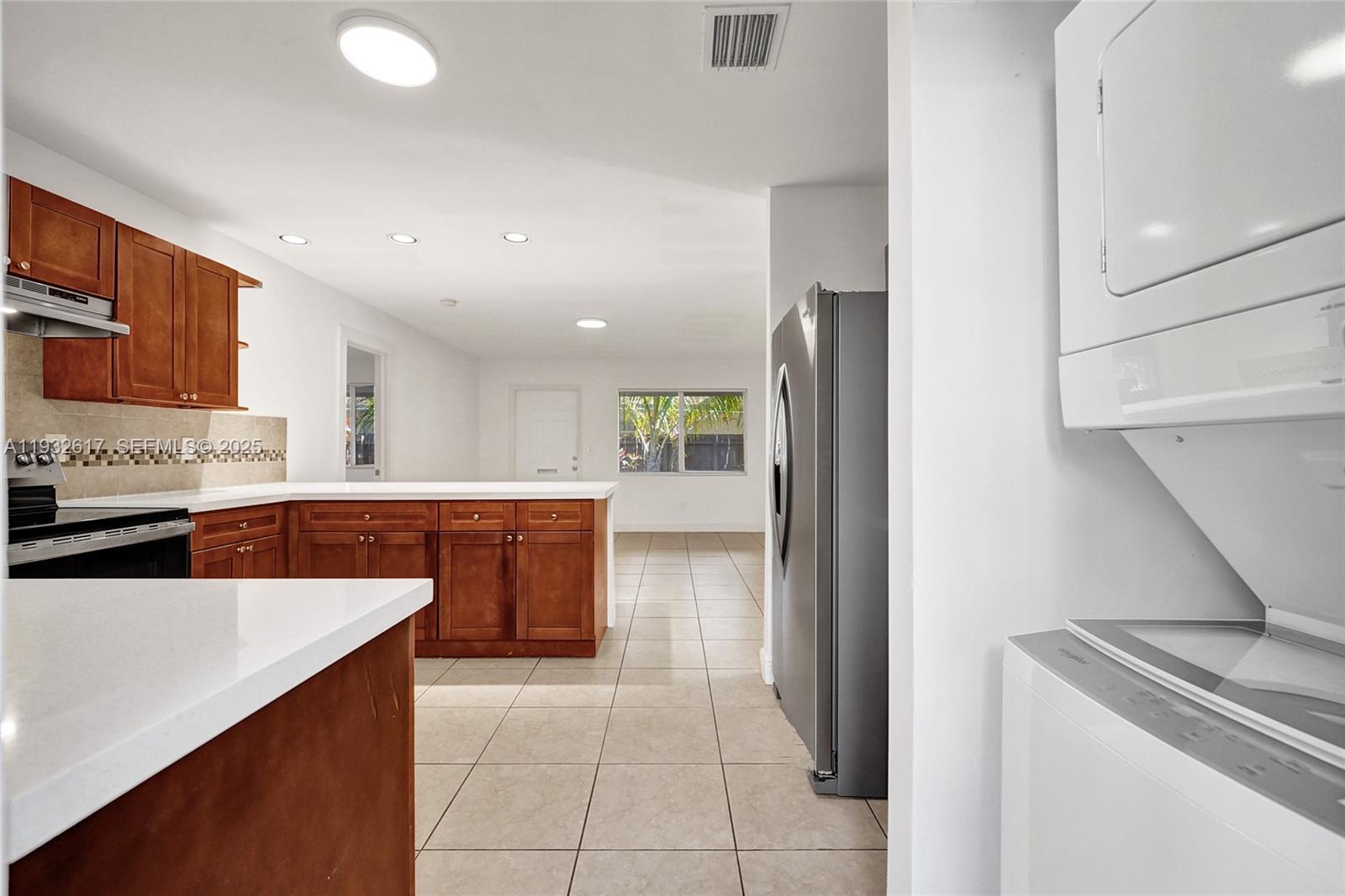 30 Southwest 8th Street, Unit 1 Hallandale Beach, FL 33009 - Photo 2 of 75 a kitchen with stainless steel appliances a stove a sink and a refrigerator