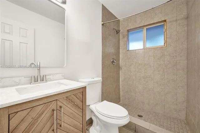 an empty room with a white walls and a window