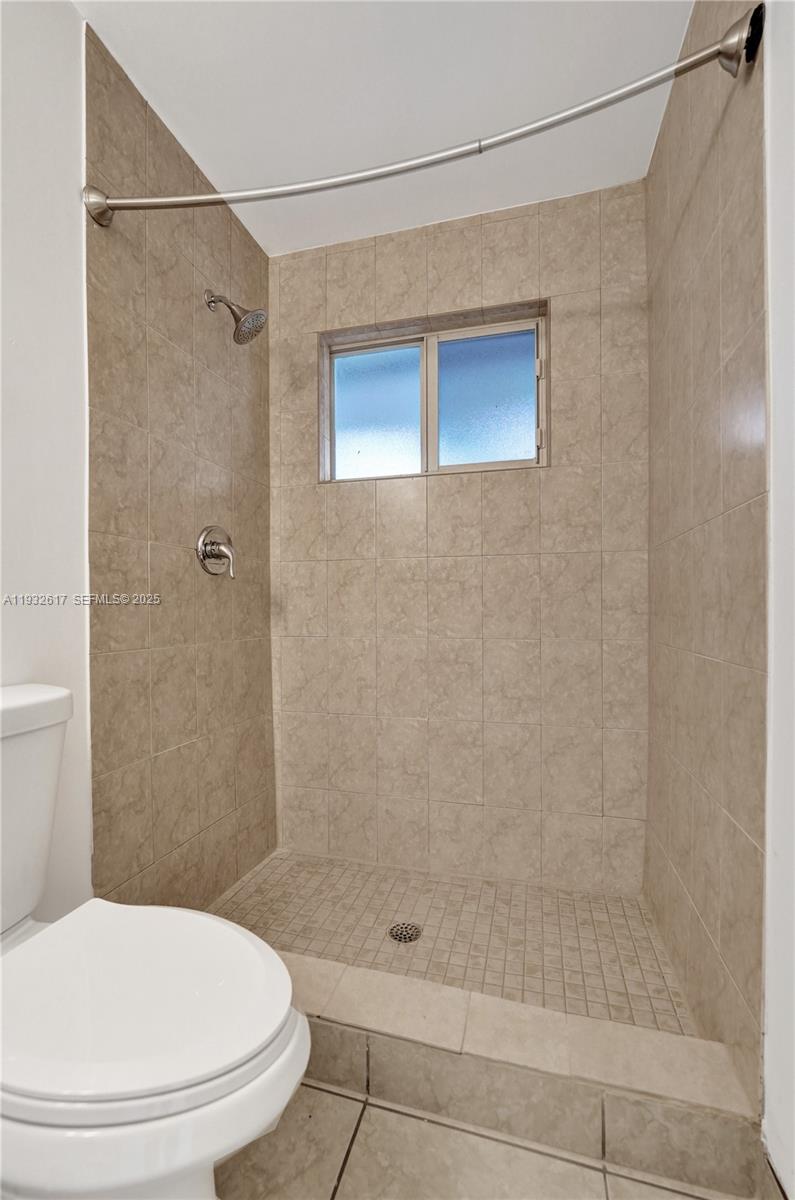 30 Southwest 8th Street, Unit 1 Hallandale Beach, FL 33009 - Photo 28 of 75 a bathroom with a shower and a toilet