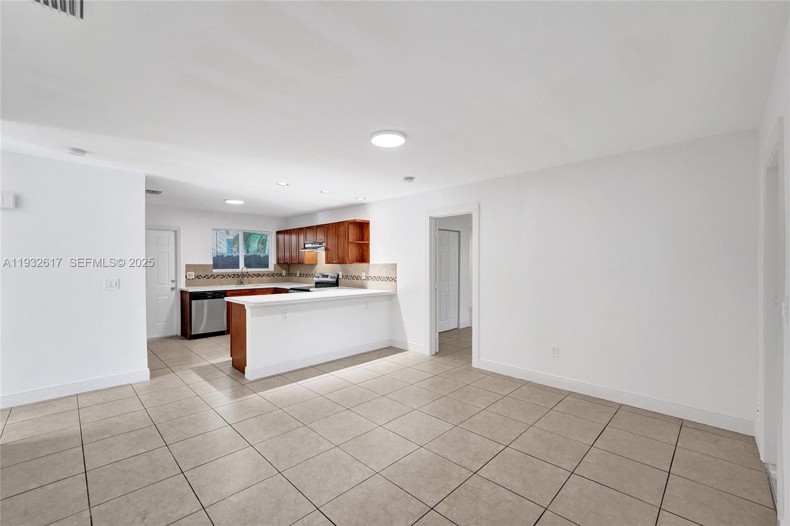 30 Southwest 8th Street, Unit 1 Hallandale Beach, FL 33009 - Photo 39 of 75 a view of kitchen with cabinets and window