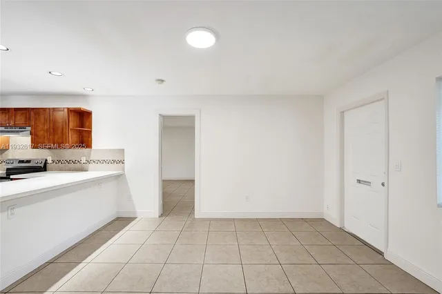 a kitchen with stainless steel appliances granite countertop wooden cabinets a stove top oven a sink and dishwasher