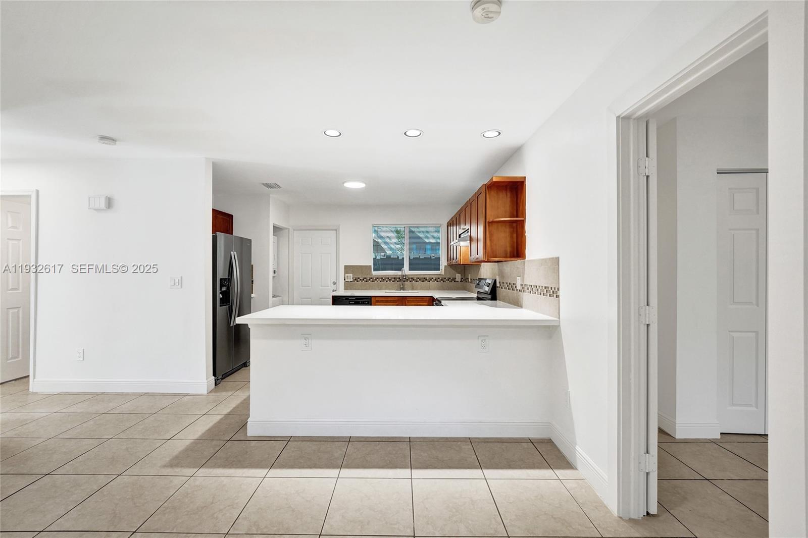 30 Southwest 8th Street, Unit 1 Hallandale Beach, FL 33009 - Photo 46 of 75 a view of kitchen with stainless steel appliances granite countertop a refrigerator and a sink