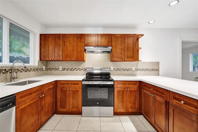 a bathroom with a granite countertop bathtub shower and toilet