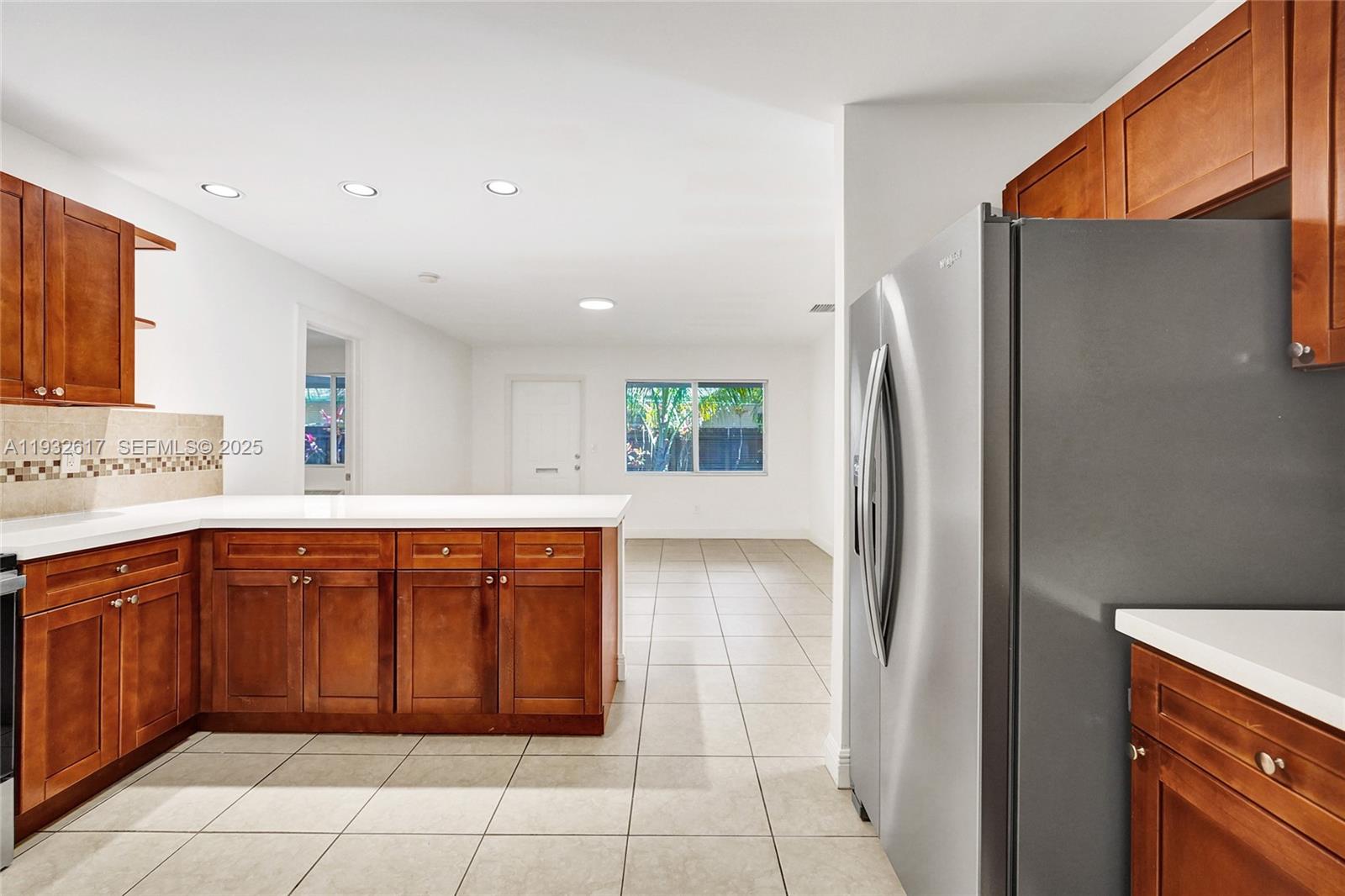30 Southwest 8th Street, Unit 1 Hallandale Beach, FL 33009 - Photo 52 of 75 a kitchen with stainless steel appliances granite countertop a refrigerator and a sink
