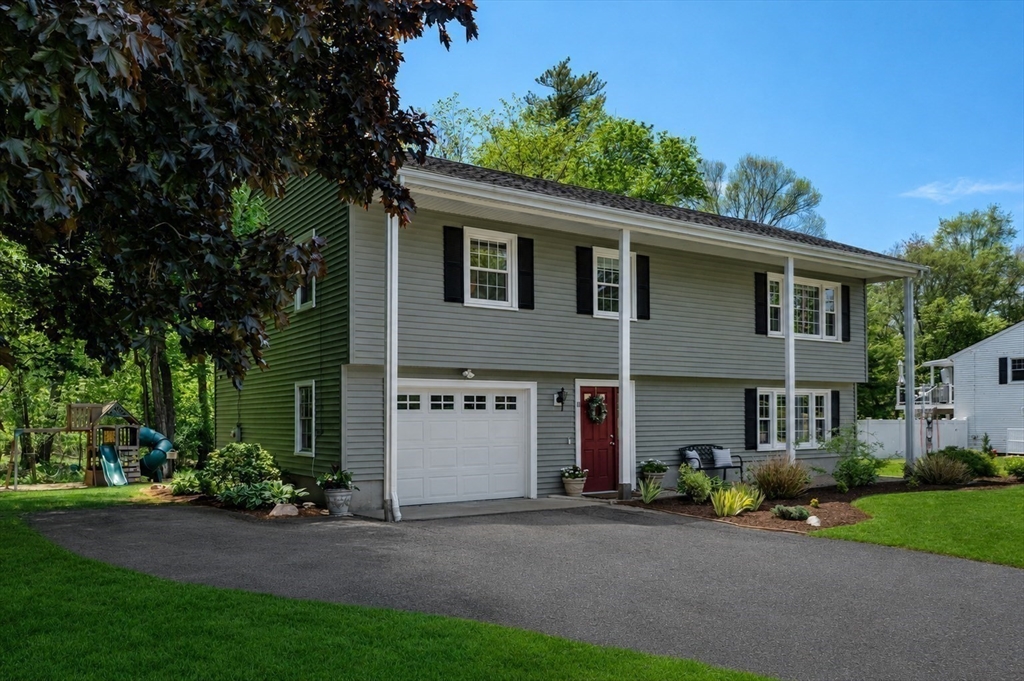 11 Longmeadow Road Medfield, MA 02052 - Photo 33 of 39 a front view of a house with a garden and plants