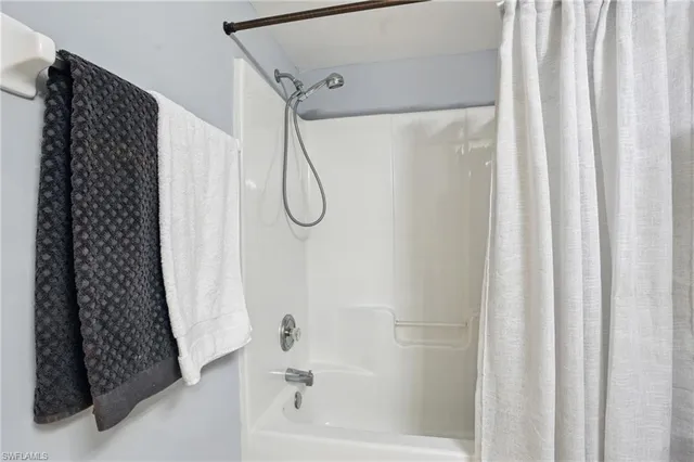a bathroom with a shower curtain and a bathtub