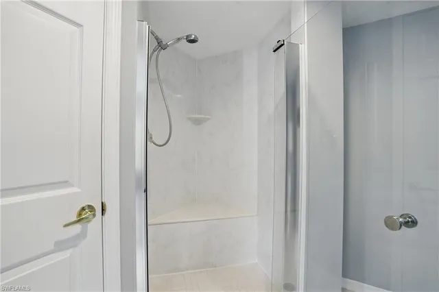 a bathroom with a glass shower door