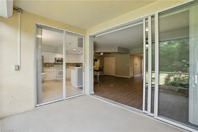 a view of a glass door and a living room