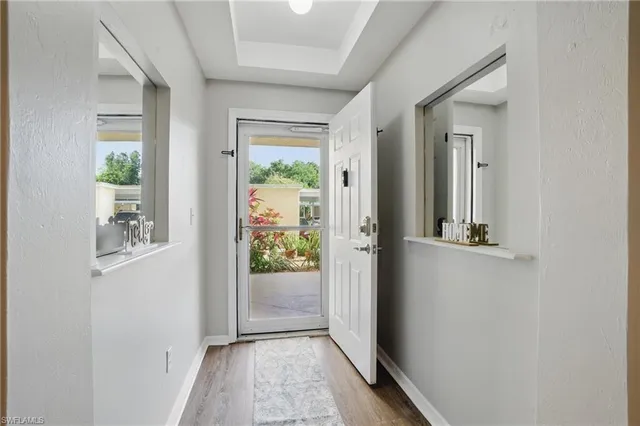 a view of a hallway with windows and entryway