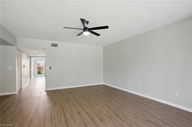 a view of a room with wooden floor and window