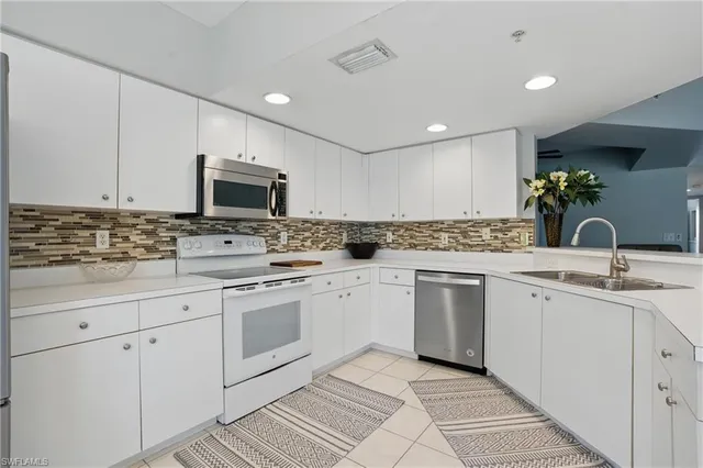 a kitchen with appliances cabinets and a sink