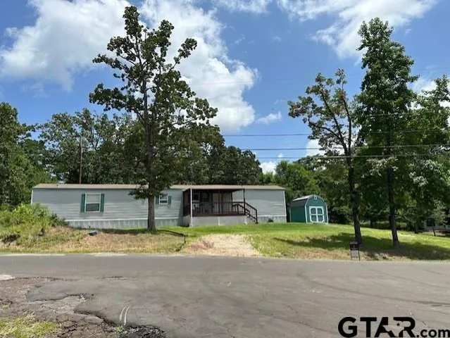 a front view of a house with a yard and a garage
