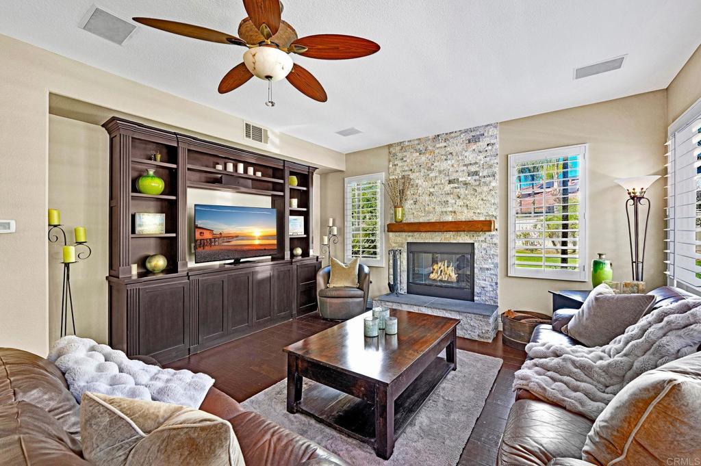 1463 Belmont Park Road Oceanside, CA 92057 - Photo 11 of 50 a living room with furniture a flat screen tv and a fireplace