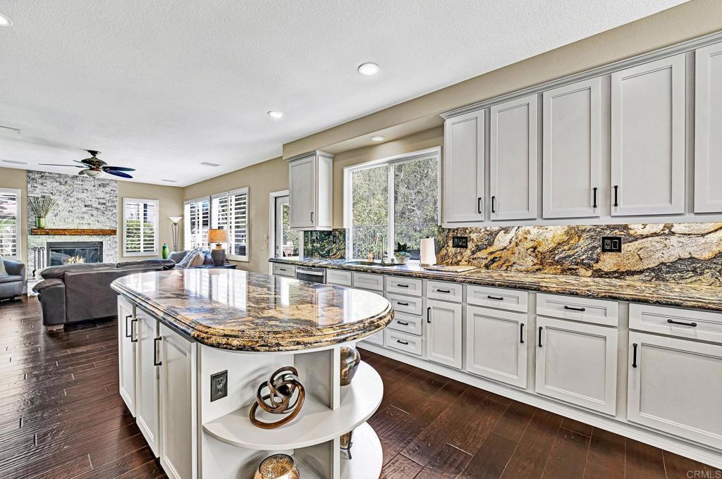 1463 Belmont Park Road Oceanside, CA 92057 - Photo 16 of 50 a kitchen with stainless steel appliances granite countertop a sink a stove and a center island