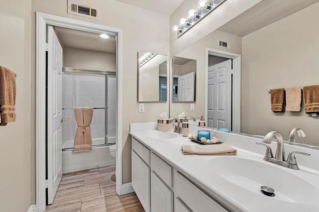1463 Belmont Park Road Oceanside, CA 92057 - Photo 35 of 50 a bathroom with a sink and a mirror