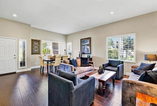 a living room with fireplace furniture and a wooden floor
