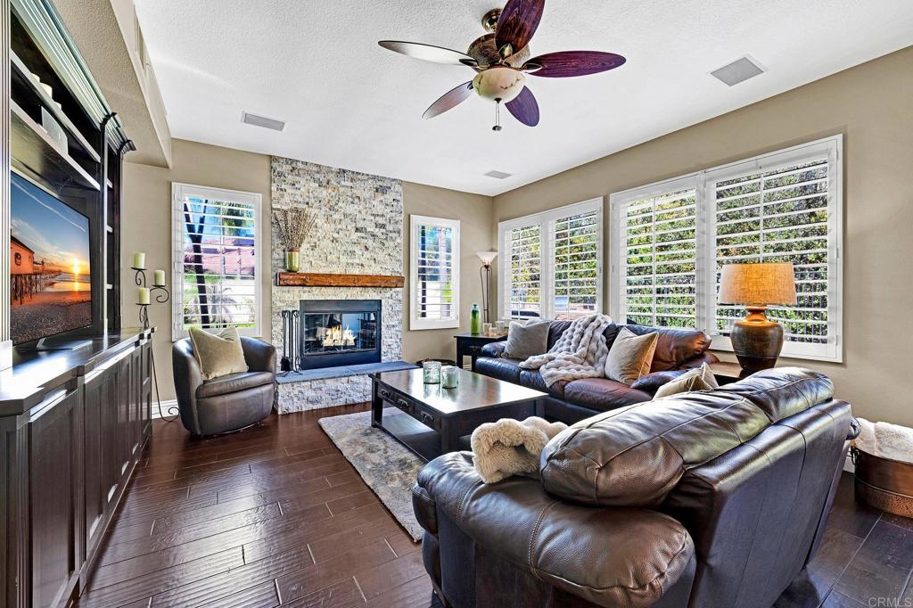 1463 Belmont Park Road Oceanside, CA 92057 - Photo 9 of 50 a living room with furniture a flat screen tv and a fireplace