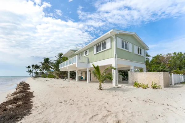a view of a deck with chairs a barbeque with wooden floor and fence
