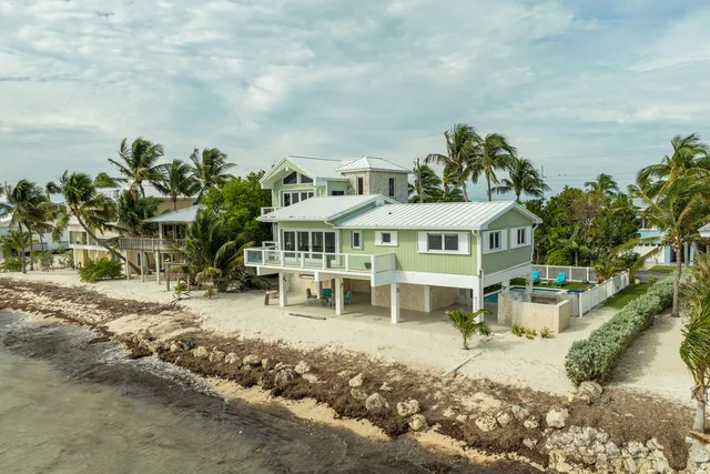 a view of a dining room with furniture large windows and wooden floor
